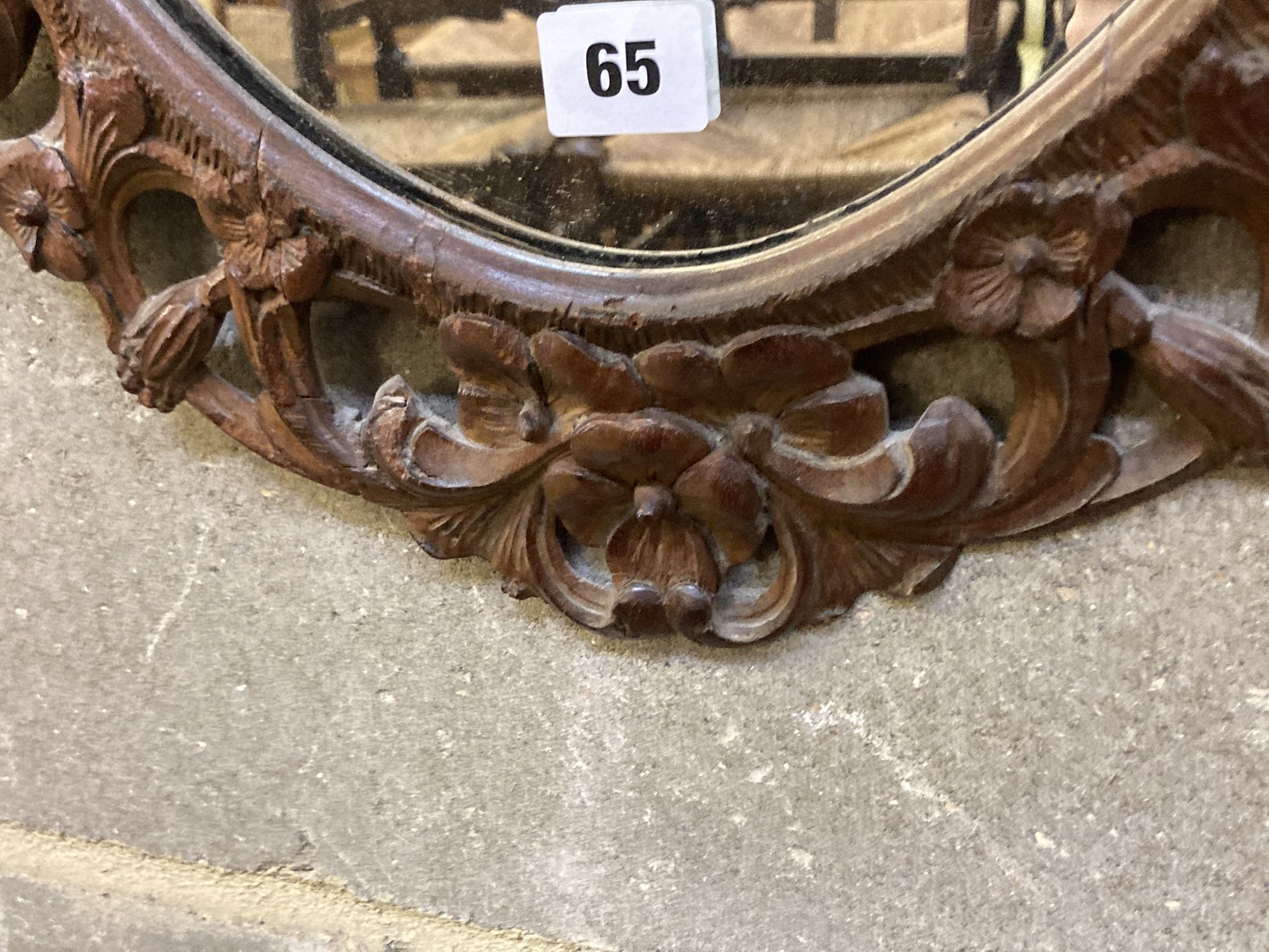 A Carolean style carved walnut oval mirror, width 48cm, height 68cm